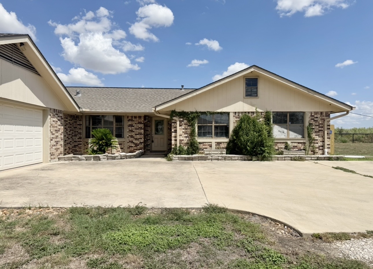 18512 Carlson Lane Elgin, TX 78621 - Photo 1 of 29 An expansive concrete driveway leads directly to this classic brick-accented ranch home.