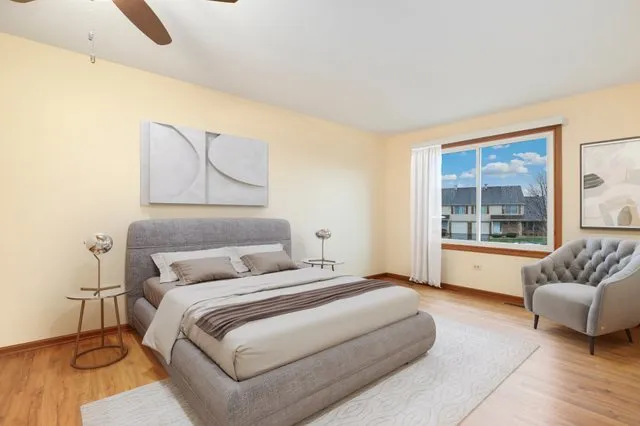 a bedroom with a bed and couch with window