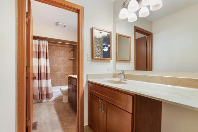 a bathroom with a sink a light fixture and a mirror