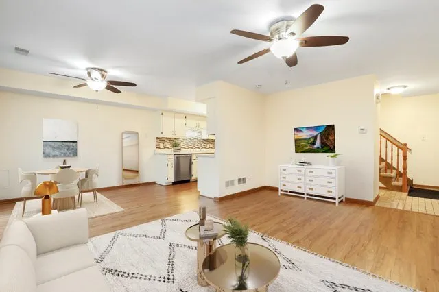 a living room with furniture and kitchen view