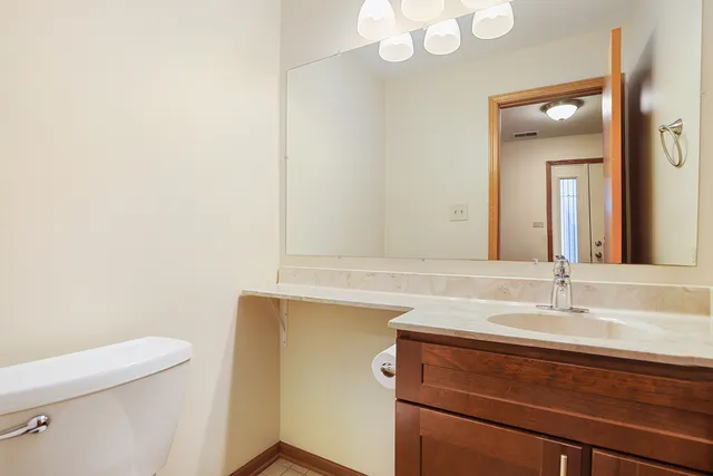 a bathroom with a sink a toilet and mirror