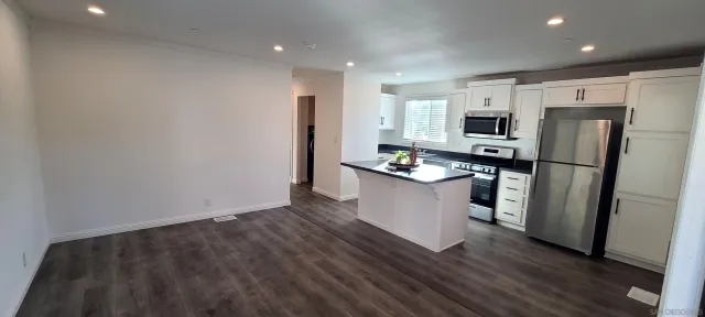 a kitchen with stainless steel appliances a refrigerator and a sink