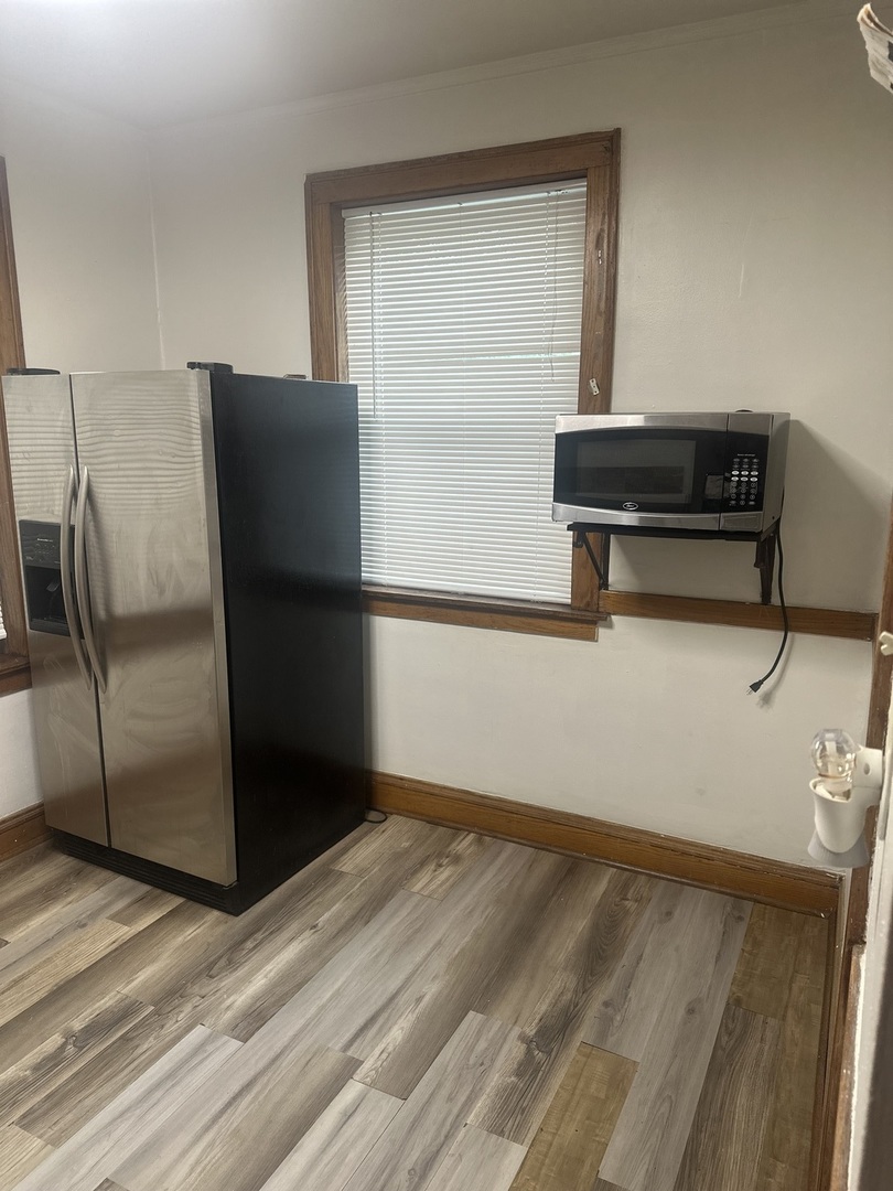 6837 South Maplewood Avenue, Unit 1R Chicago, IL 60629 - Photo 11 of 16 a kitchen with a refrigerator and a stove