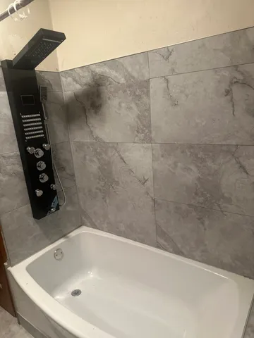 a bath tub sitting next to a white toilet