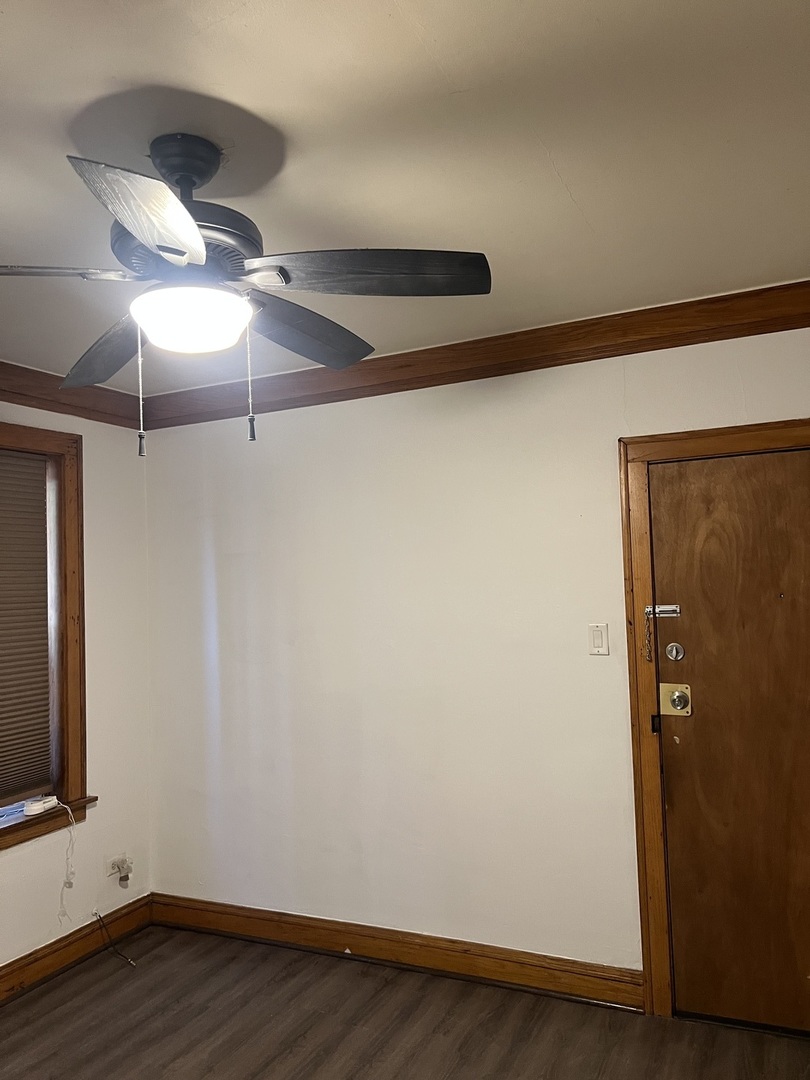 6837 South Maplewood Avenue, Unit 1R Chicago, IL 60629 - Photo 2 of 16 a view of an empty room with wooden floor and a window