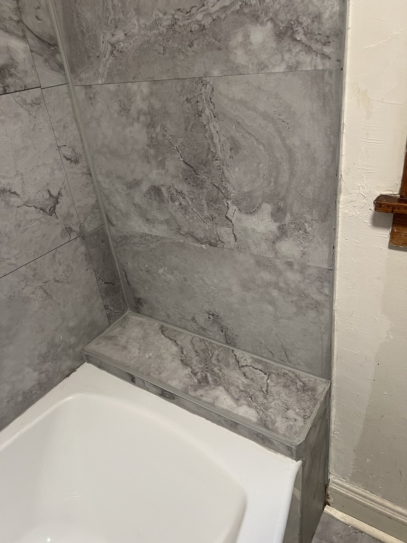 6837 South Maplewood Avenue, Unit 1R Chicago, IL 60629 - Photo 5 of 16 a bathroom with a granite countertop sink