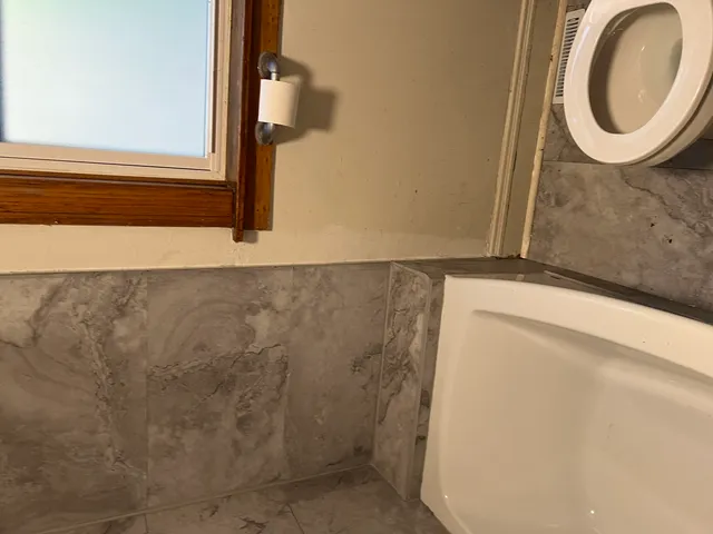 a bathroom with a mirror and a shower