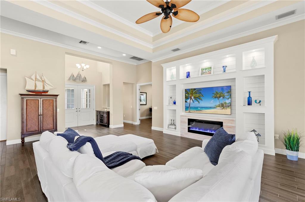 4922 Andros Drive Naples, FL 34113 - Photo 12 of 44 a living room with furniture and a flat screen tv