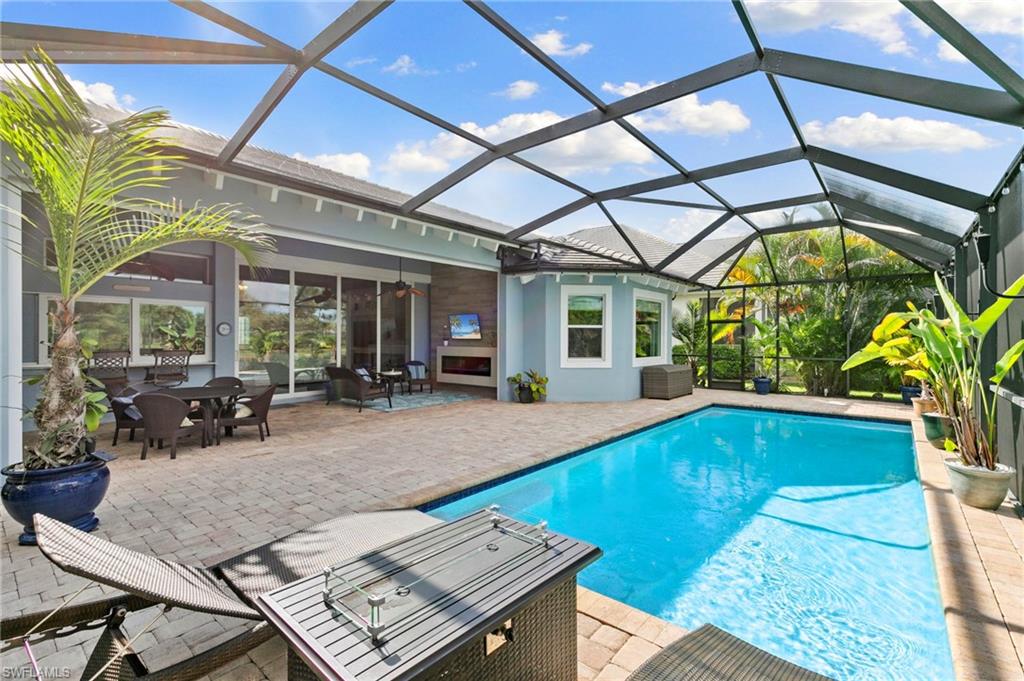 4922 Andros Drive Naples, FL 34113 - Photo 16 of 44 a view of swimming pool with outdoor seating