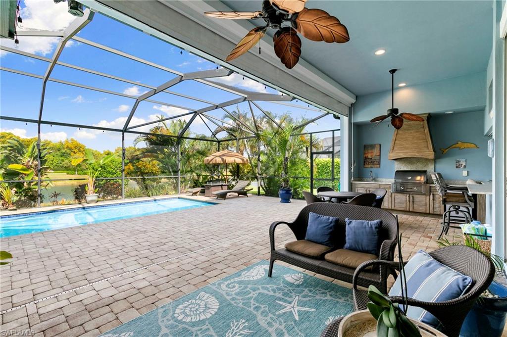 4922 Andros Drive Naples, FL 34113 - Photo 19 of 44 a living room with patio furniture and a floor to ceiling window