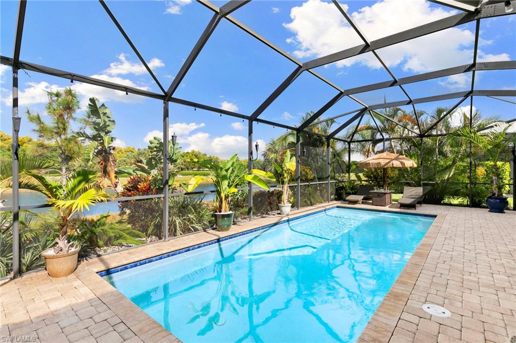 4922 Andros Drive Naples, FL 34113 - Photo 20 of 44 a view of a swimming pool with a patio