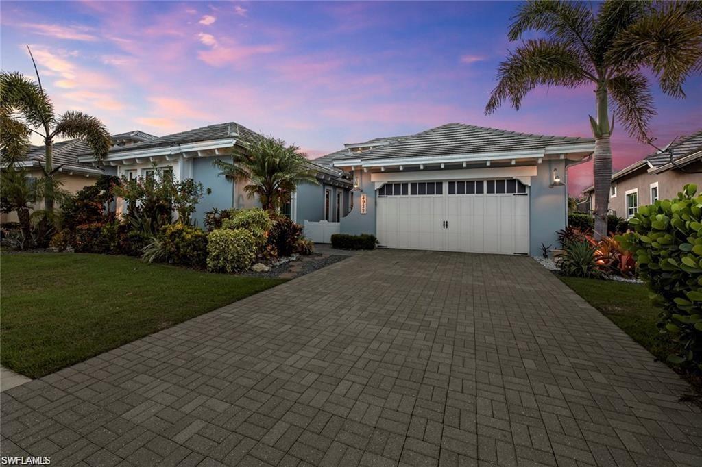 4922 Andros Drive Naples, FL 34113 - Photo 2 of 44 a view of a house with a garden