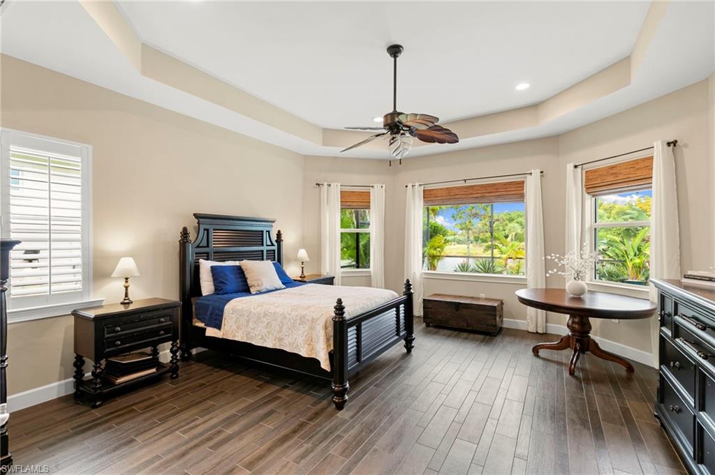 4922 Andros Drive Naples, FL 34113 - Photo 22 of 44 a bedroom with a bed table and chairs