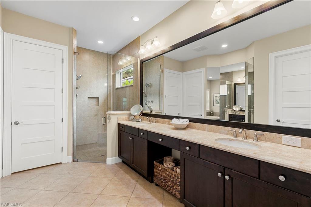 4922 Andros Drive Naples, FL 34113 - Photo 24 of 44 a bathroom with a granite countertop sink and a mirror