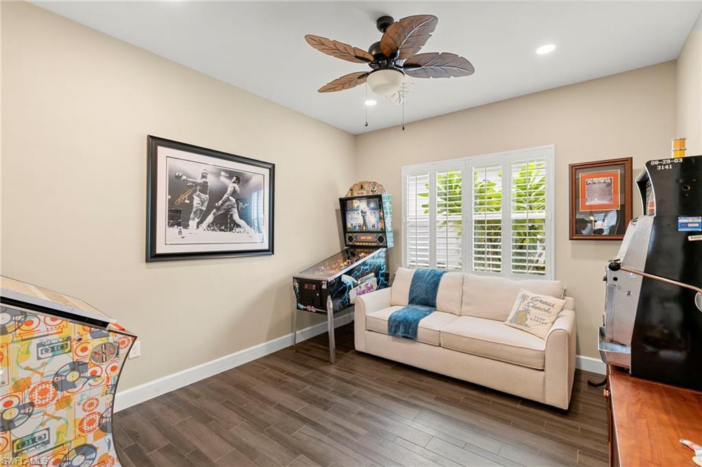 4922 Andros Drive Naples, FL 34113 - Photo 26 of 44 a living room with furniture and a flat screen tv