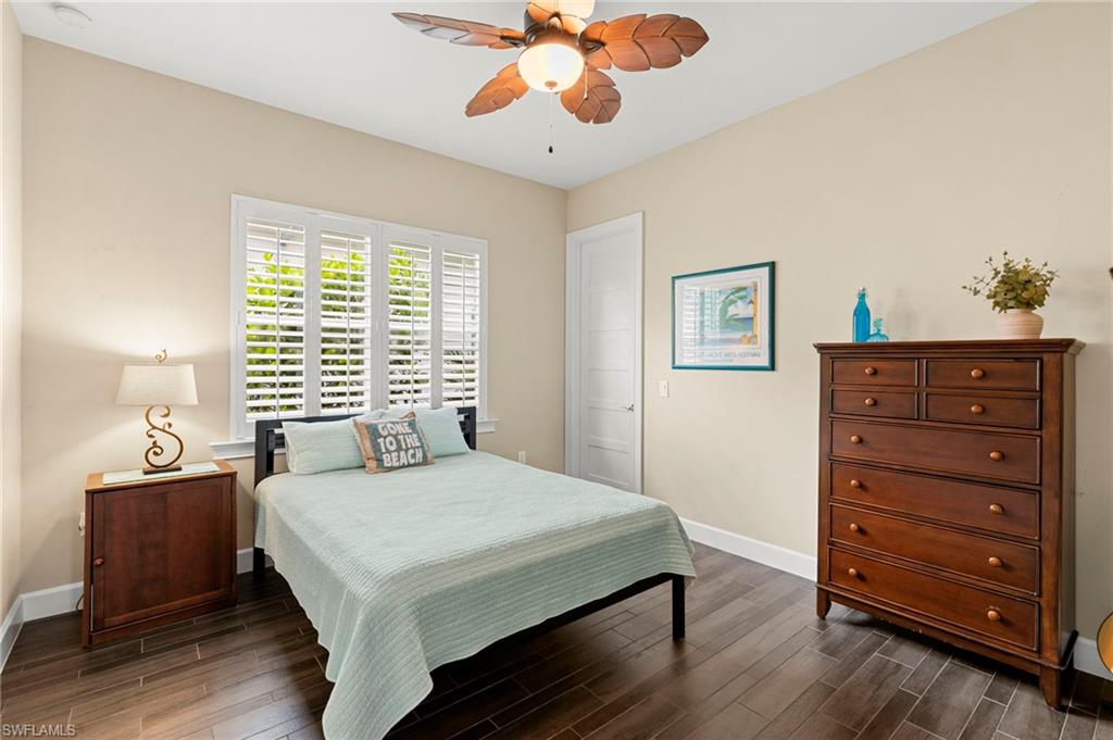4922 Andros Drive Naples, FL 34113 - Photo 28 of 44 a bedroom with a bed and a dresser