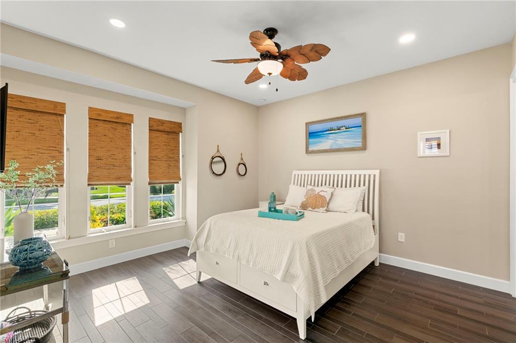 4922 Andros Drive Naples, FL 34113 - Photo 29 of 44 a bedroom with a large bed and a large window