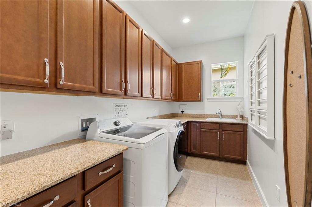 4922 Andros Drive Naples, FL 34113 - Photo 32 of 44 a kitchen with stainless steel appliances granite countertop a sink a stove and a refrigerator
