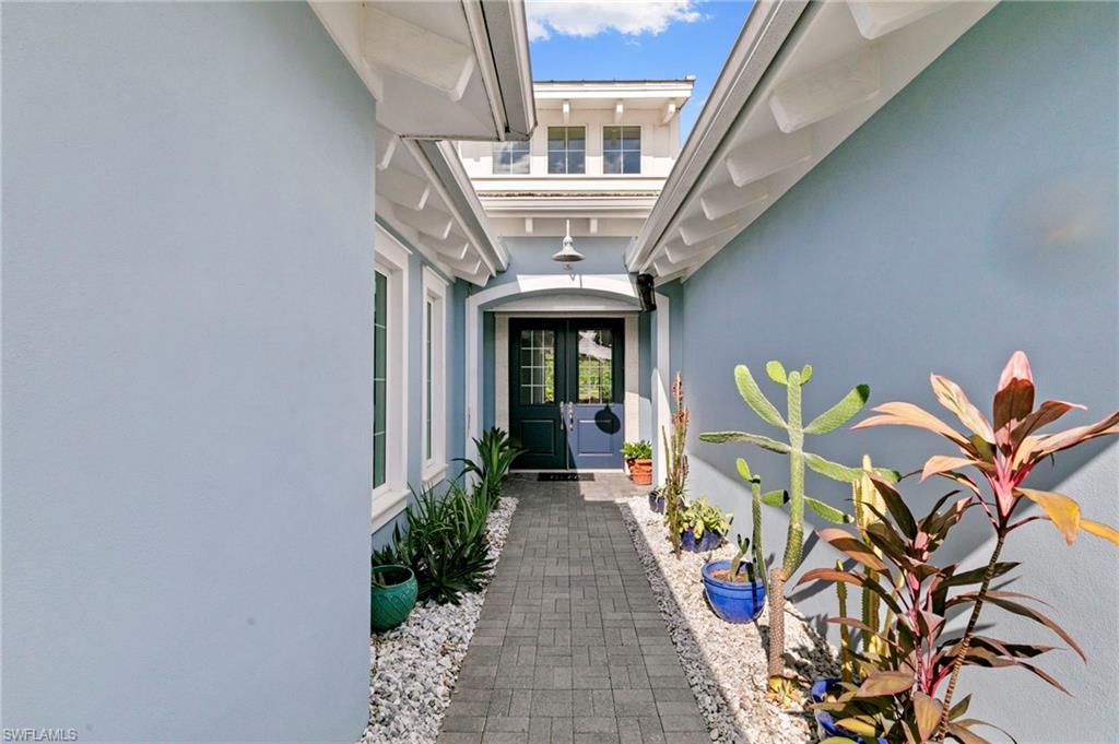 4922 Andros Drive Naples, FL 34113 - Photo 35 of 44 a front view of a house with garden