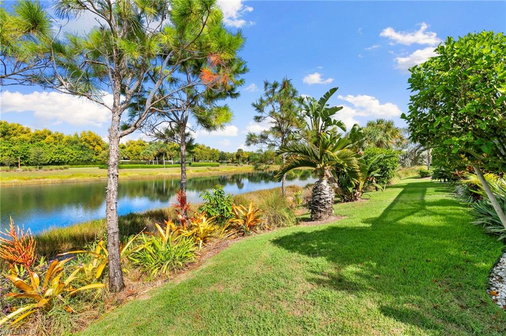 4922 Andros Drive Naples, FL 34113 - Photo 36 of 44 a view of a lake with a yard