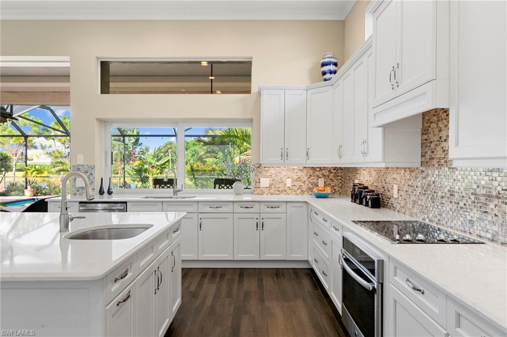4922 Andros Drive Naples, FL 34113 - Photo 7 of 44 a kitchen with a sink stove and cabinets