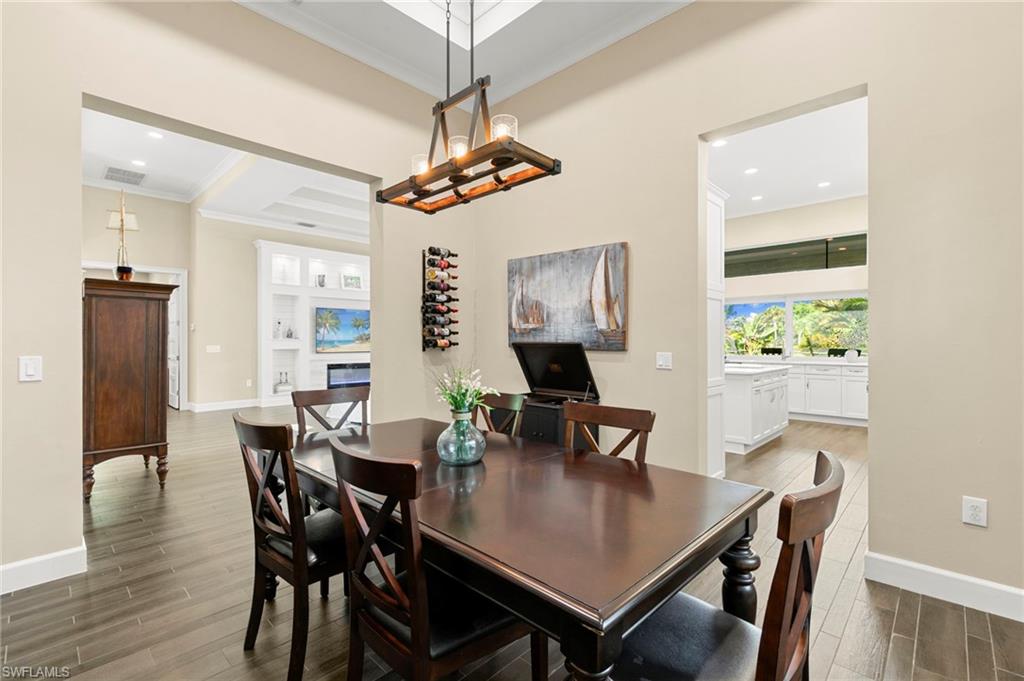 4922 Andros Drive Naples, FL 34113 - Photo 10 of 44 a view of a dining room with furniture window and wooden floor