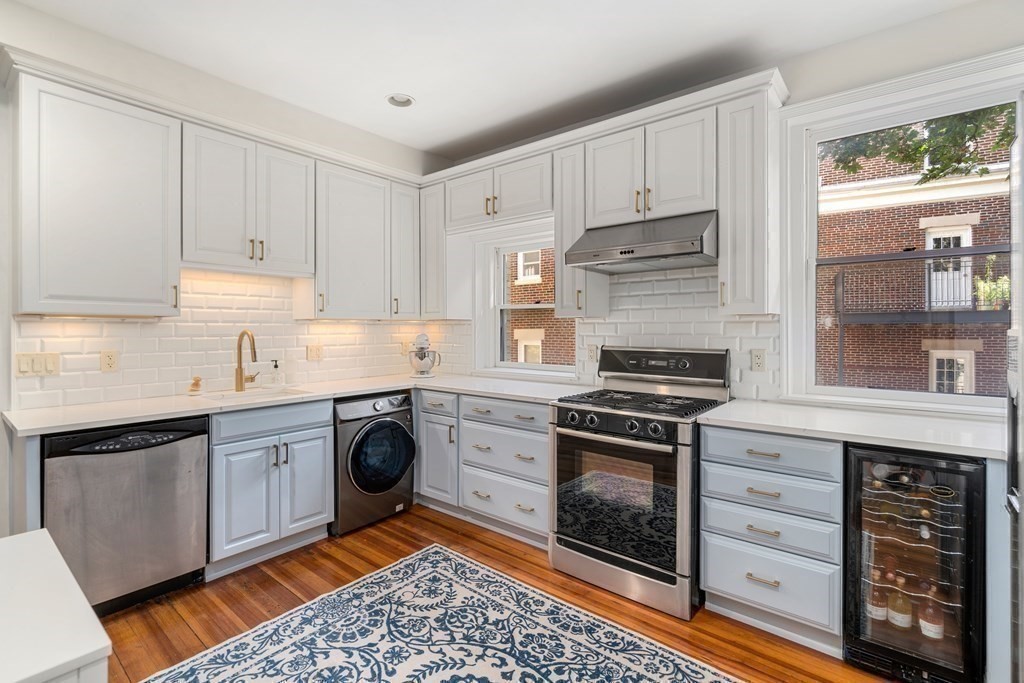 89 Mason Terrace, Unit 3 Brookline, MA 02446 - Photo 14 of 19 a kitchen with stainless steel appliances granite countertop a stove and white cabinets