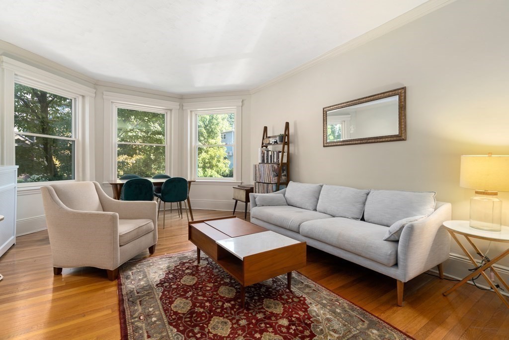 89 Mason Terrace, Unit 3 Brookline, MA 02446 - Photo 2 of 19 a living room with furniture a rug and a lamp