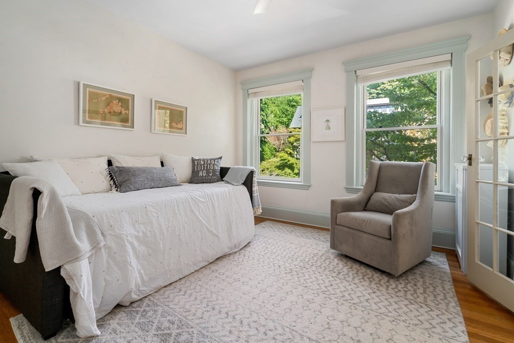 89 Mason Terrace, Unit 3 Brookline, MA 02446 - Photo 7 of 19 a bedroom with a bed and a couch with window