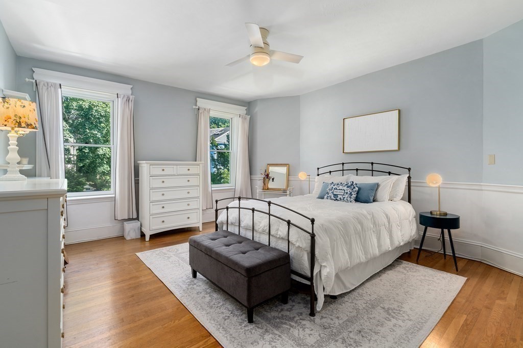 89 Mason Terrace, Unit 3 Brookline, MA 02446 - Photo 9 of 19 a bedroom with a bed couch and two windows