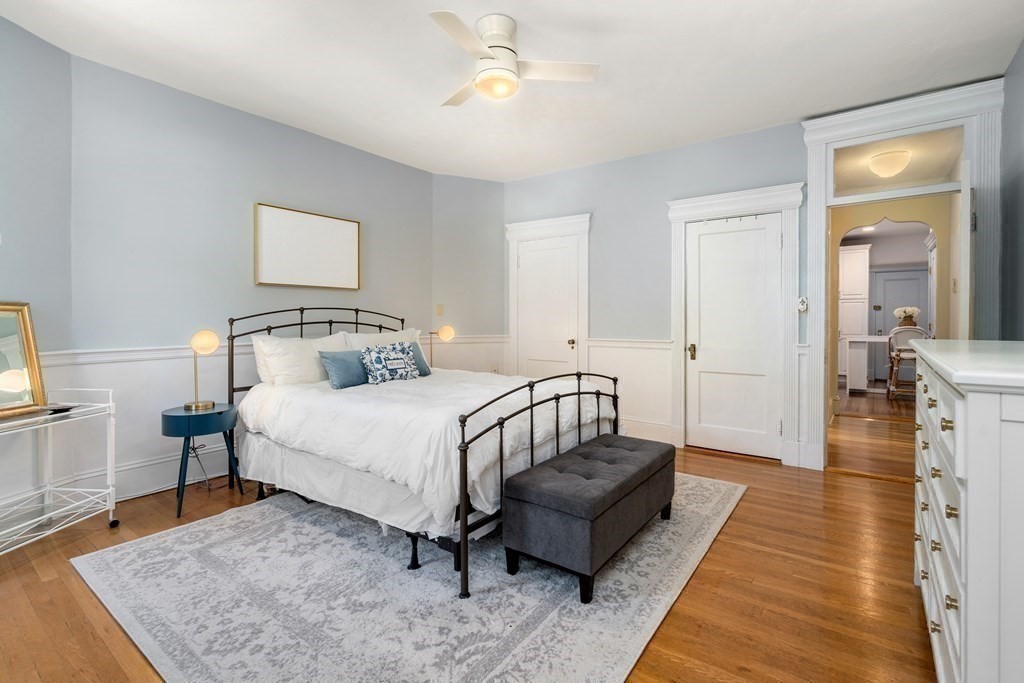 89 Mason Terrace, Unit 3 Brookline, MA 02446 - Photo 10 of 19 a bedroom with a bed rug and wooden floor