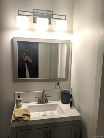a bathroom with a sink and a mirror