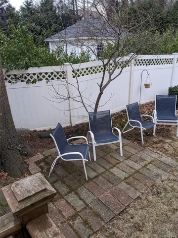 a view of a backyard with chairs
