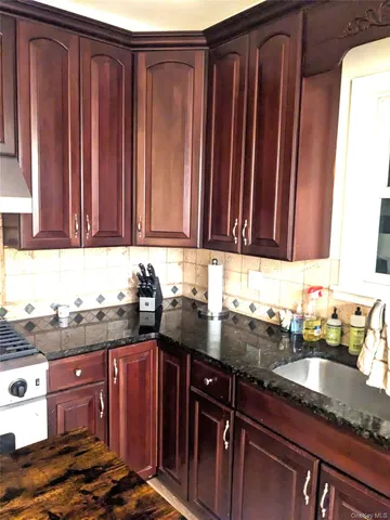 a kitchen with granite countertop cabinets and window