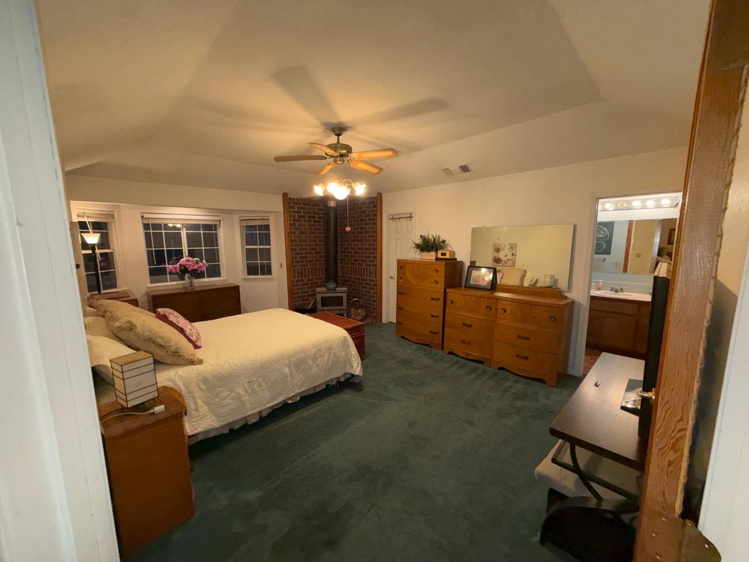 645 Rigby Lane Applegate, CA 95703 - Photo 31 of 52 a bed room with furniture and a chandelier