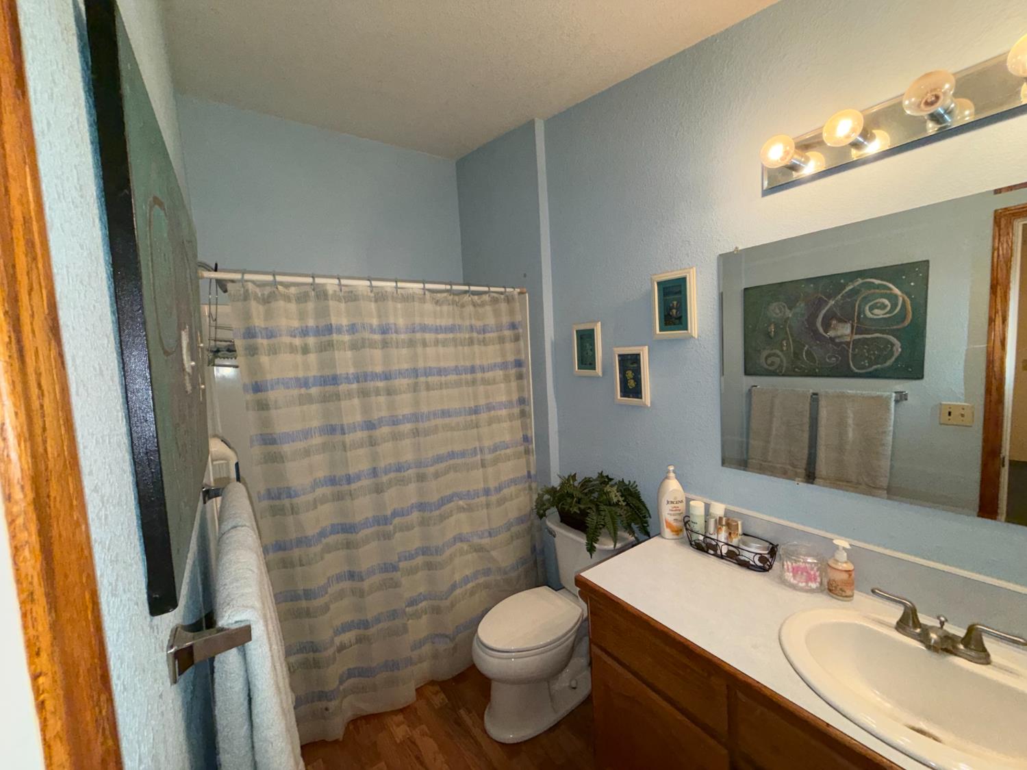 645 Rigby Lane Applegate, CA 95703 - Photo 35 of 52 a bathroom with a granite countertop toilet sink and a mirror