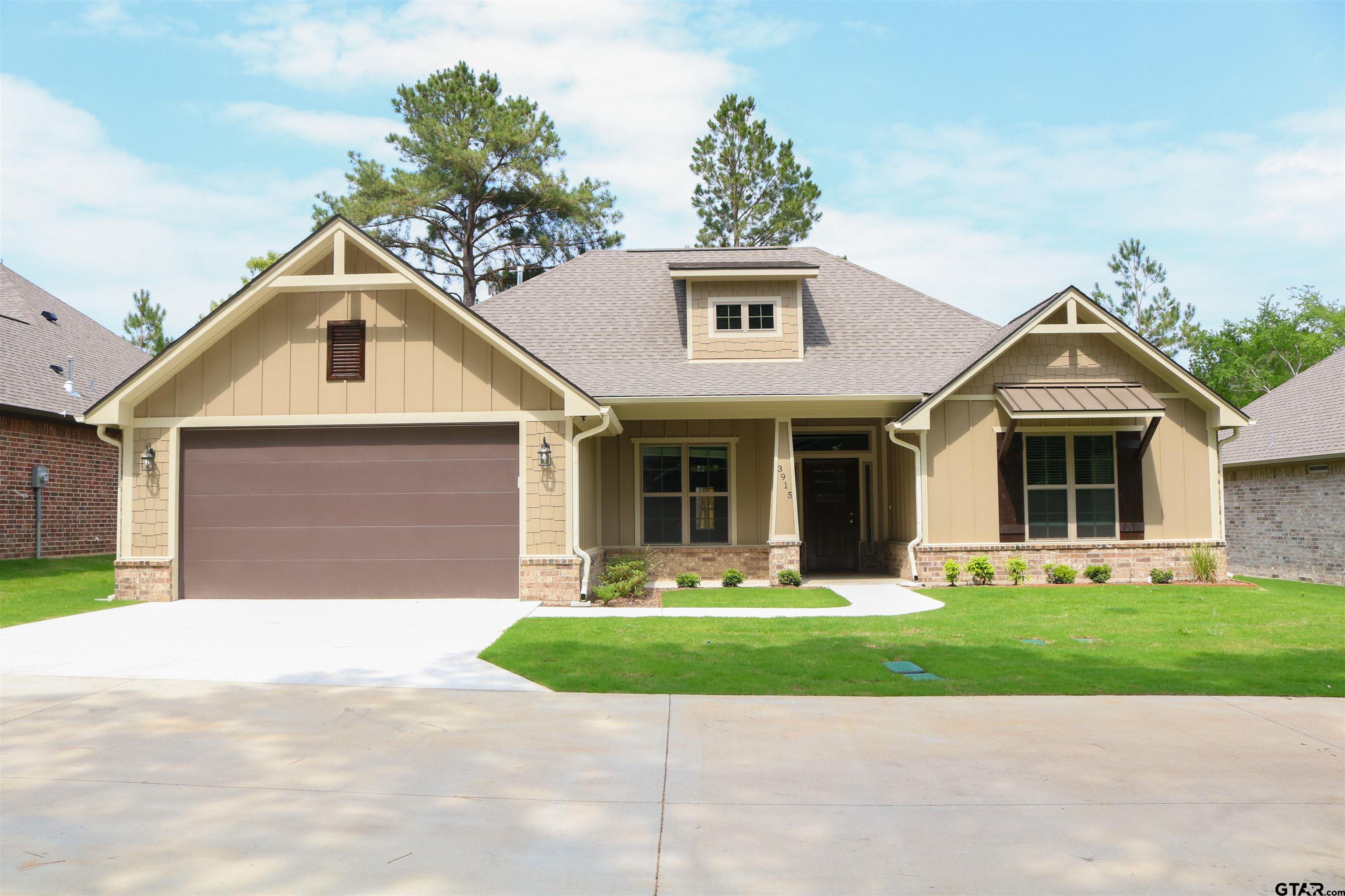3915 Old Omen Road Tyler, TX 75707 - Photo 1 of 19 a front view of a house with a yard and garage