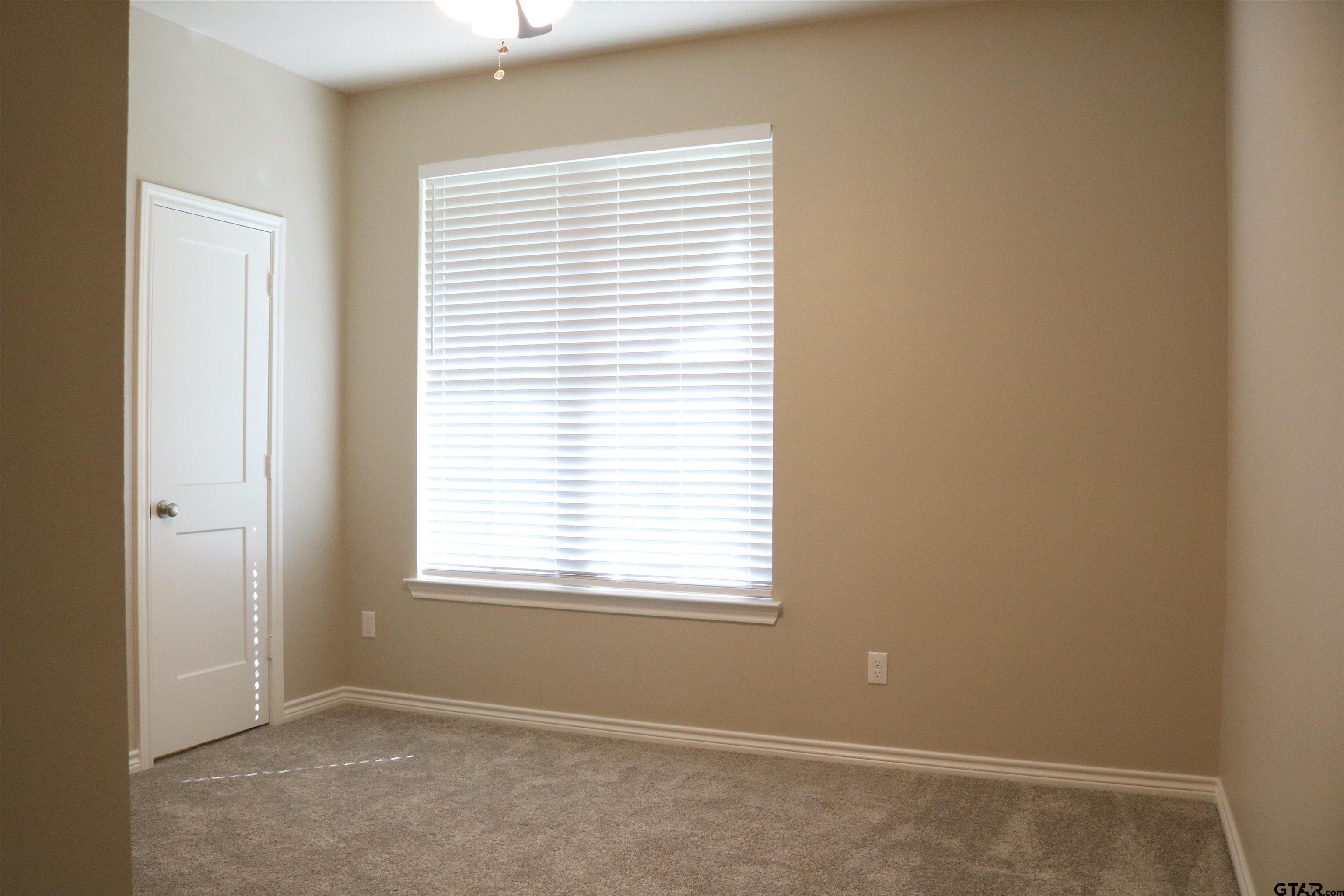3915 Old Omen Road Tyler, TX 75707 - Photo 14 of 19 an empty room with a window