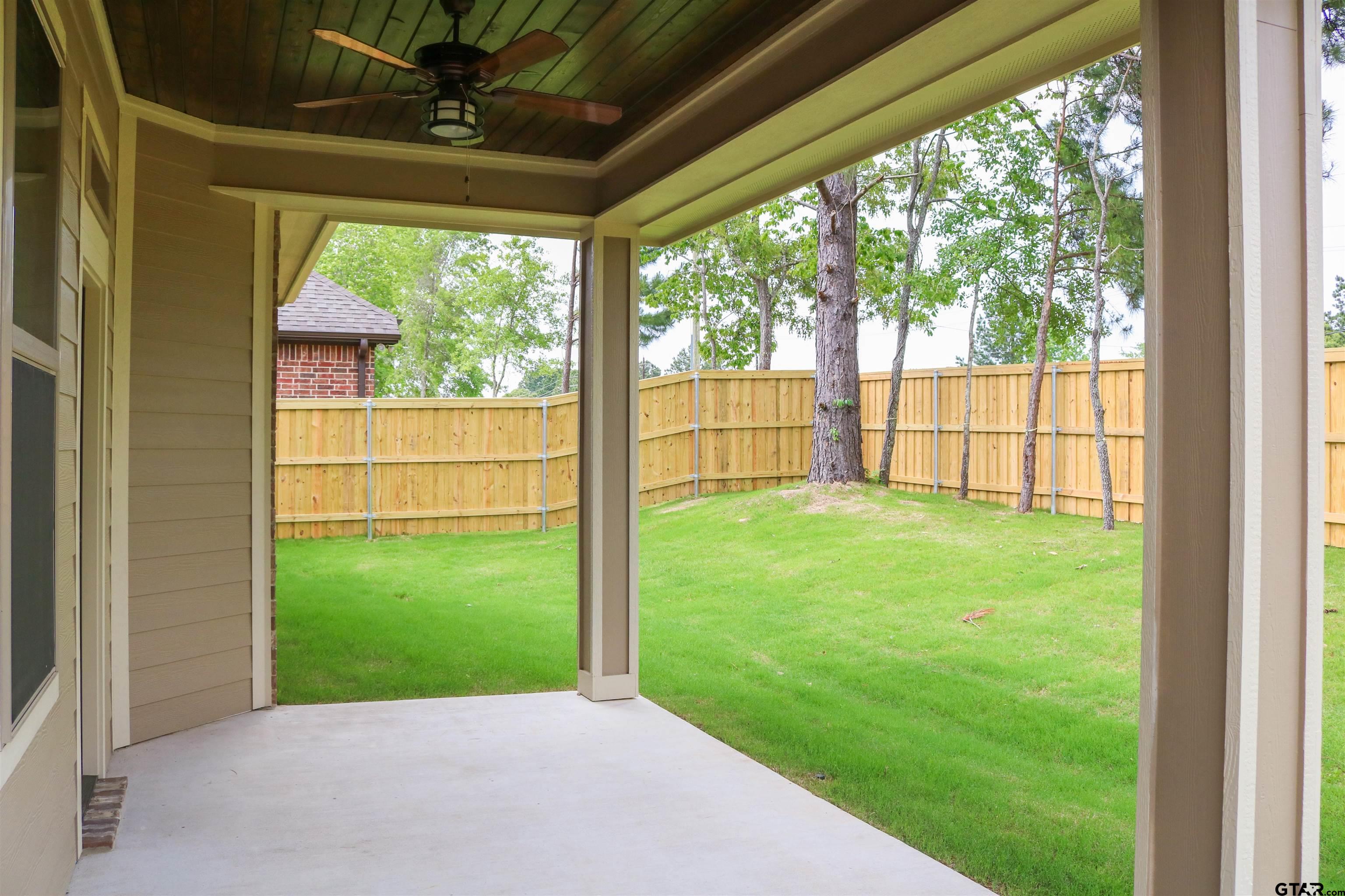 3915 Old Omen Road Tyler, TX 75707 - Photo 18 of 19 a view of a backyard with a garden