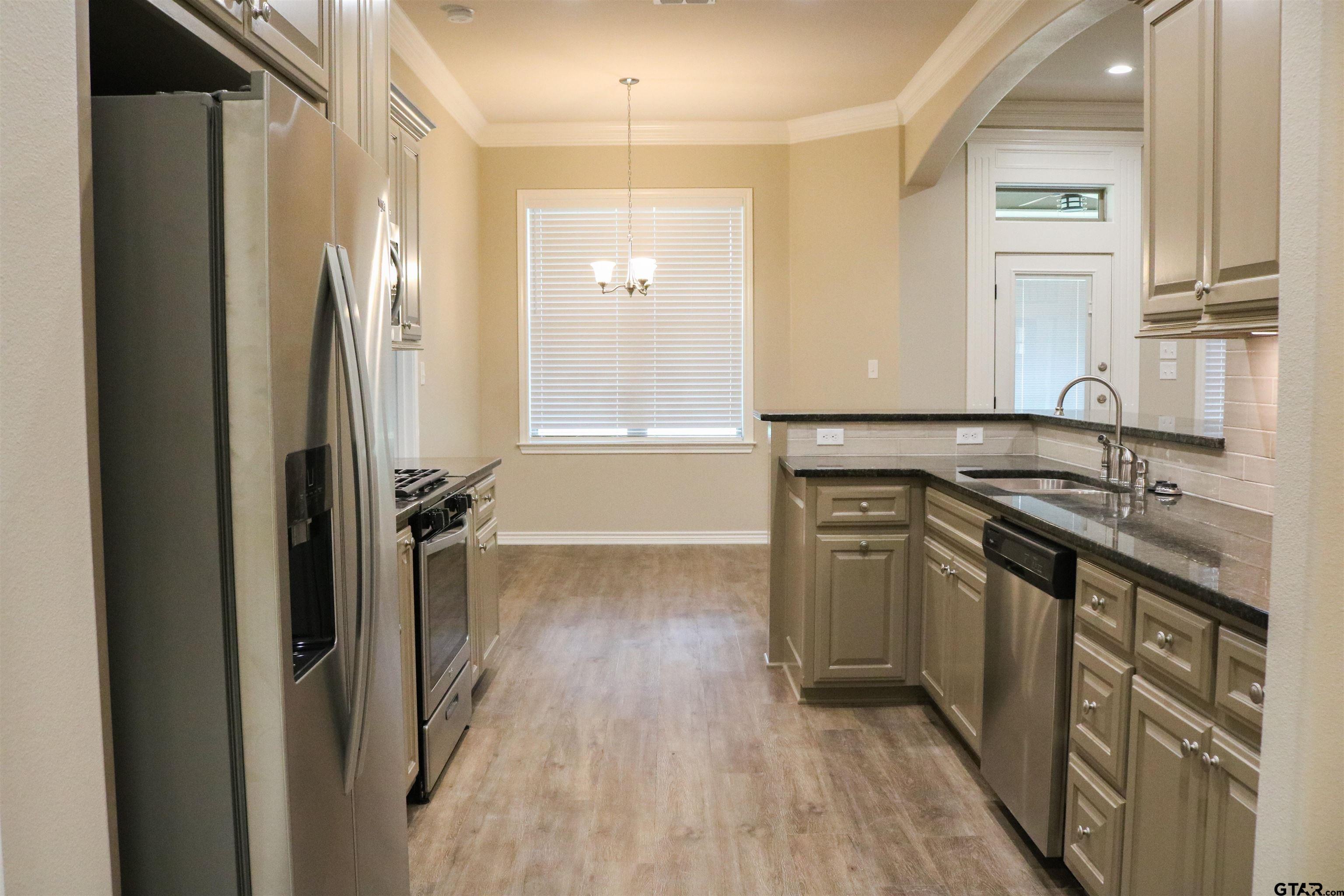 3915 Old Omen Road Tyler, TX 75707 - Photo 4 of 19 a kitchen with stainless steel appliances granite countertop a refrigerator and a sink