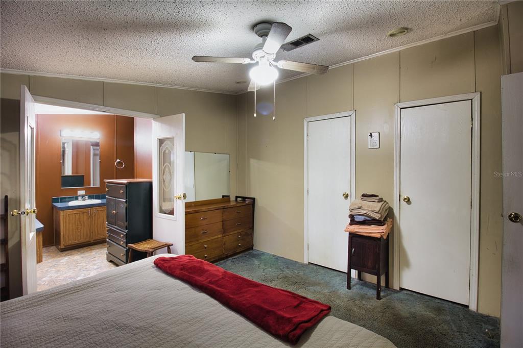 2498 Saturn Road Brooksville, FL 34604 - Photo 11 of 26 a bedroom with a bed and furniture