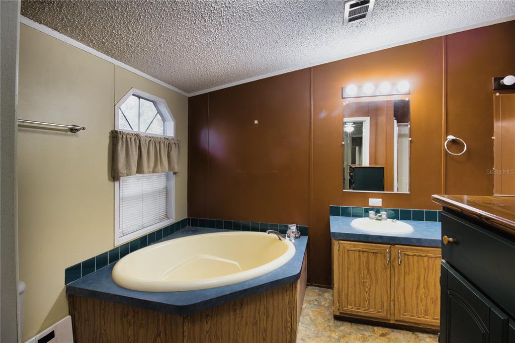 2498 Saturn Road Brooksville, FL 34604 - Photo 12 of 26 a bathroom with a sink and a mirror