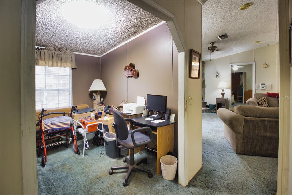 2498 Saturn Road Brooksville, FL 34604 - Photo 14 of 26 a view of a livingroom with workspace and a window