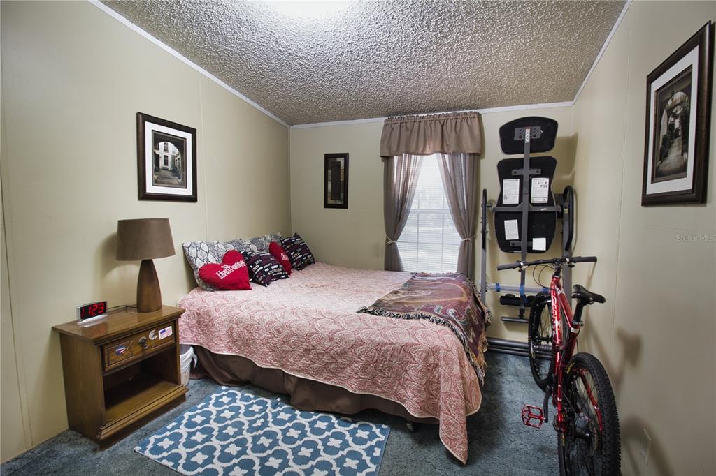 2498 Saturn Road Brooksville, FL 34604 - Photo 15 of 26 a bedroom with bed and a window