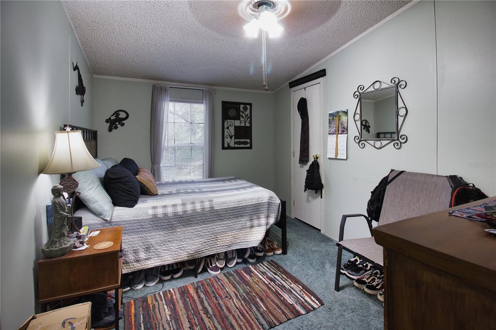 2498 Saturn Road Brooksville, FL 34604 - Photo 16 of 26 a bedroom with a bed and wooden floor