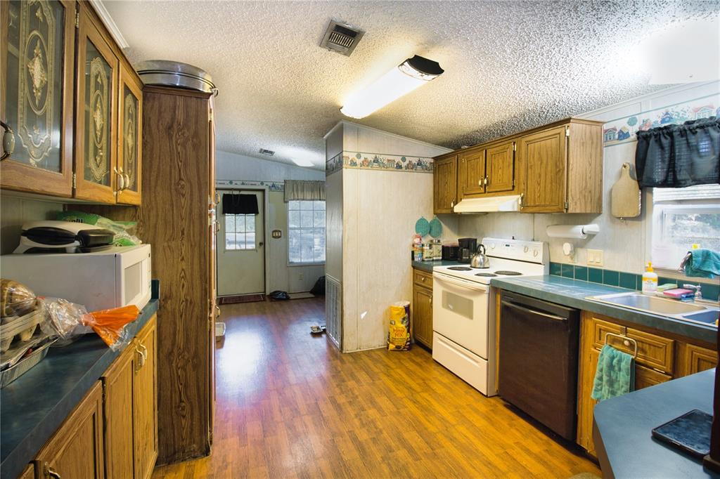 2498 Saturn Road Brooksville, FL 34604 - Photo 9 of 26 a kitchen with a sink wooden floor and stainless steel appliances