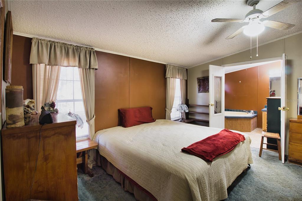 2498 Saturn Road Brooksville, FL 34604 - Photo 10 of 26 a bedroom with a bed and dresser with mirror