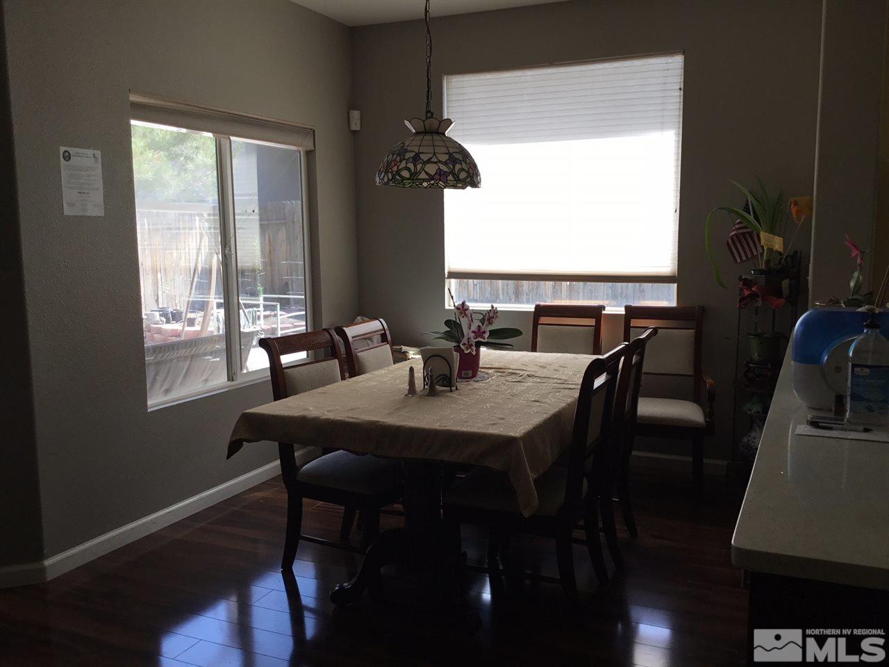1432 Gaucho Lane Reno, NV 89521 - Photo 3 of 13 a view of a dining room with furniture window and wooden floor