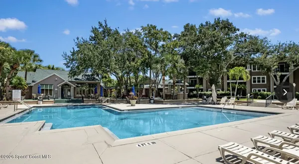 a room with a table chairs and painted walls