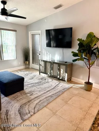 a bed sitting in a bedroom next to a lamp